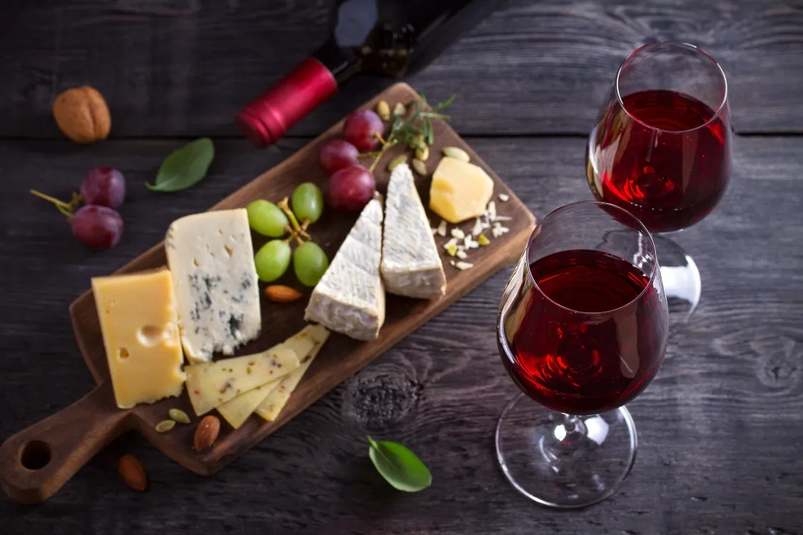red wine and different kinds of cheese