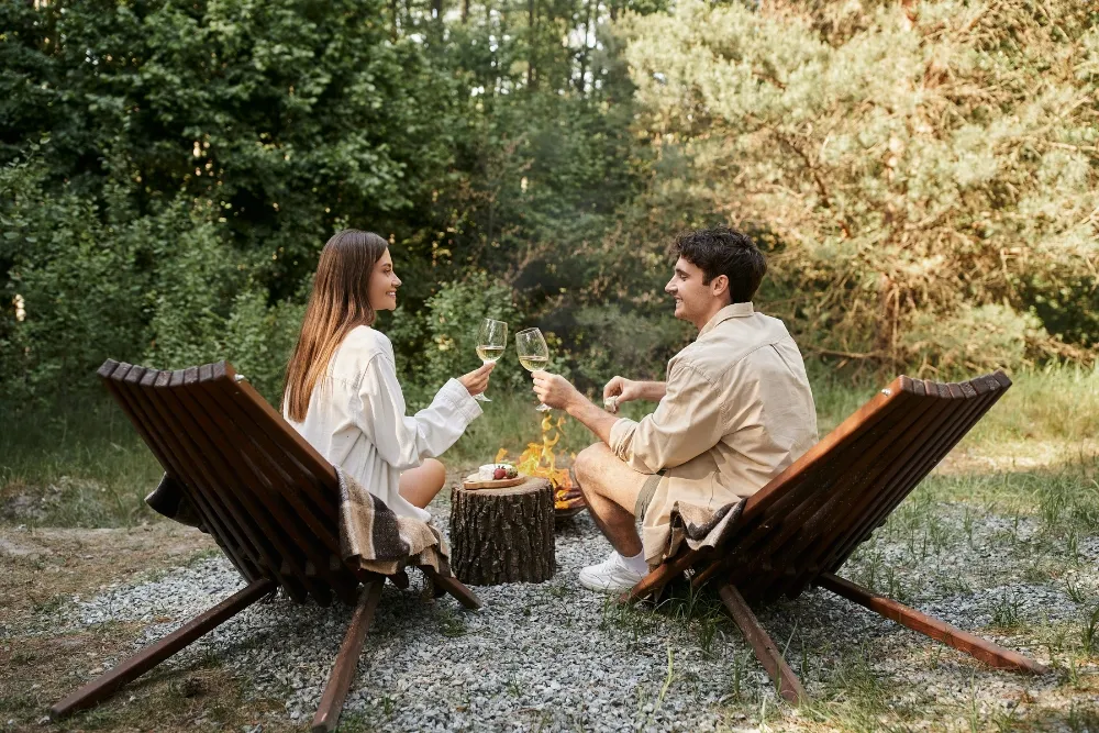 side view of smiling romantic couple holding wine